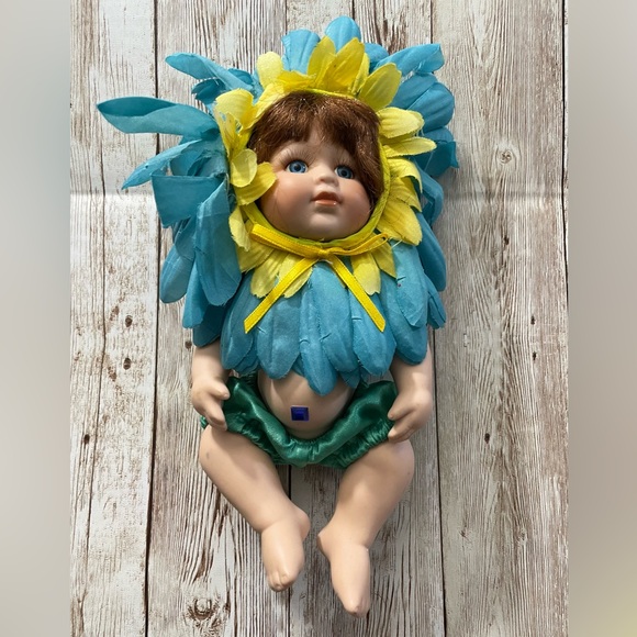 Collectible Porcelain Baby Doll Dressed in a Blue & Yellow Flower Costume - Picture 2 of 10